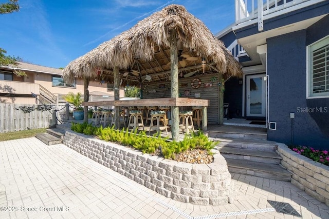 view of patio with a gazebo and exterior bar