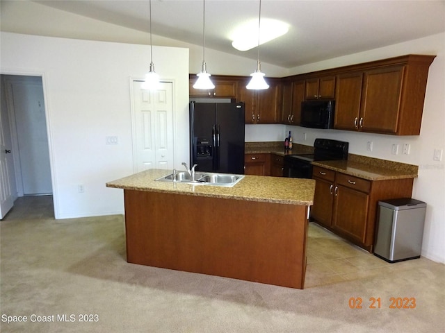 kitchen with light colored carpet, sink, black appliances, pendant lighting, and an island with sink