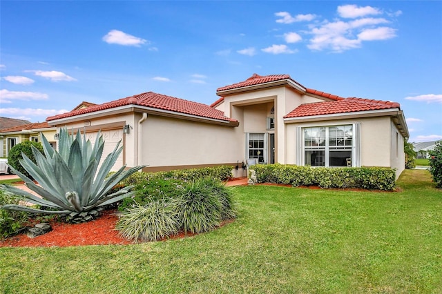 view of front of property with a front yard and a garage