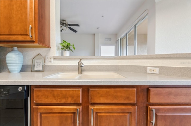 kitchen with black dishwasher, ceiling fan, and sink