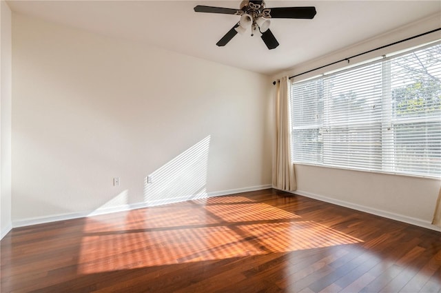 empty room with dark hardwood / wood-style floors and ceiling fan