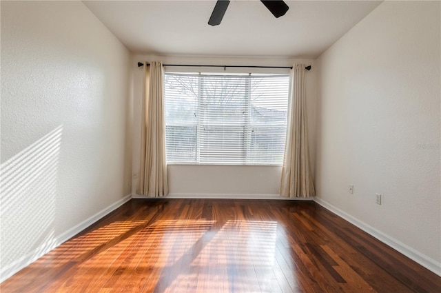 unfurnished room with dark hardwood / wood-style flooring and ceiling fan