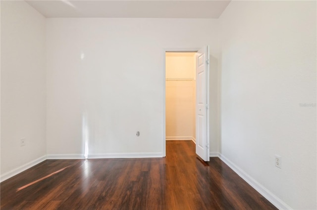 spare room featuring dark hardwood / wood-style flooring