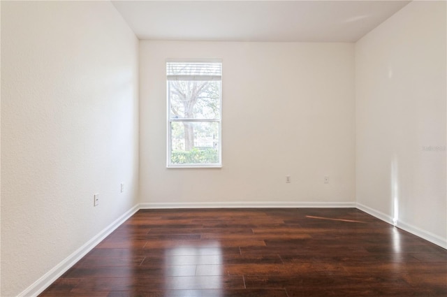 spare room featuring dark hardwood / wood-style flooring