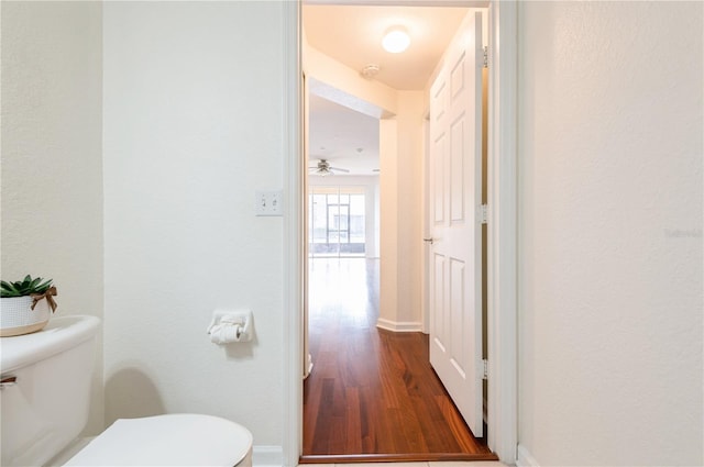 bathroom featuring hardwood / wood-style flooring and toilet