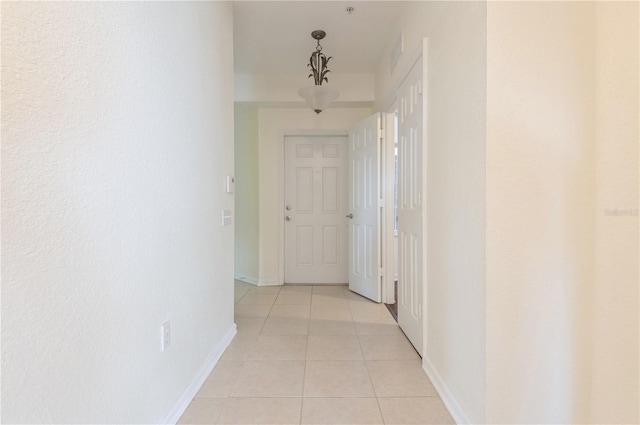 hall featuring light tile patterned floors