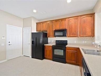 kitchen with black appliances and sink