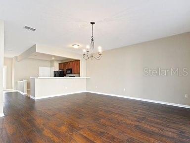 interior space featuring a notable chandelier and dark hardwood / wood-style floors