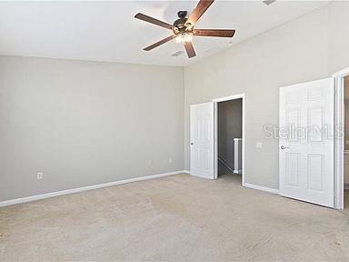 unfurnished bedroom with light carpet and ceiling fan