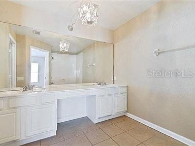 bathroom featuring tile patterned floors, vanity, and a chandelier