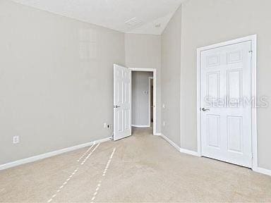 unfurnished bedroom featuring high vaulted ceiling