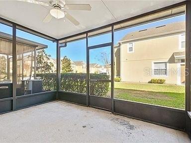 unfurnished sunroom with ceiling fan and a healthy amount of sunlight