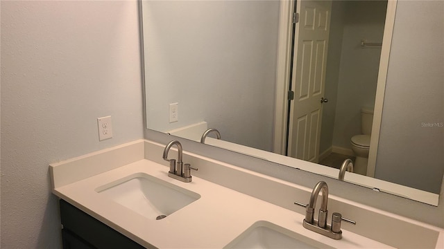 bathroom featuring vanity and toilet