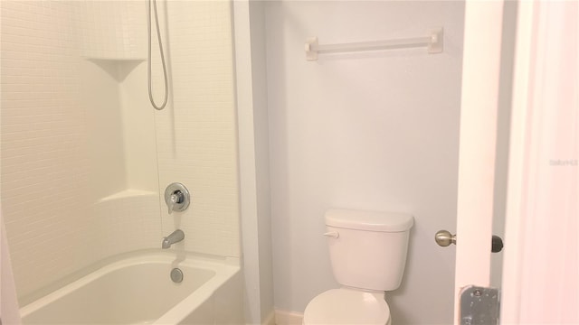 bathroom featuring shower / bathing tub combination and toilet