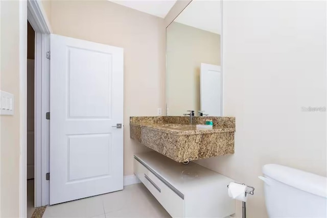 bathroom featuring tile patterned floors, toilet, and sink