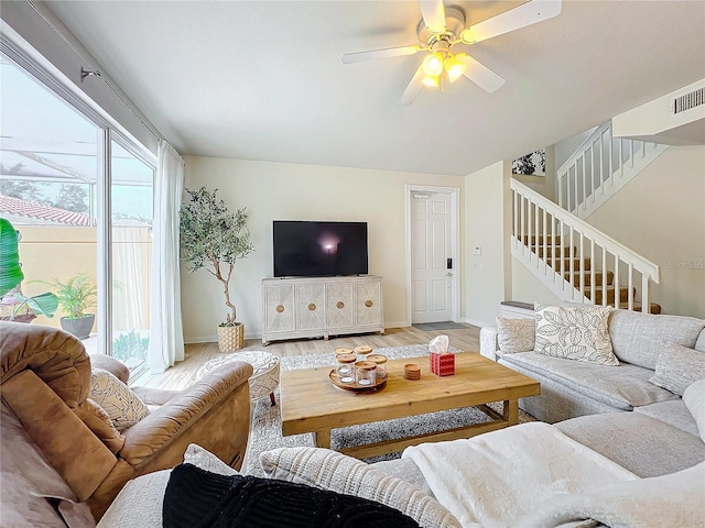 living room with hardwood / wood-style flooring and ceiling fan