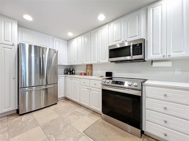 kitchen featuring white cabinetry, light tile patterned floors, and stainless steel appliances