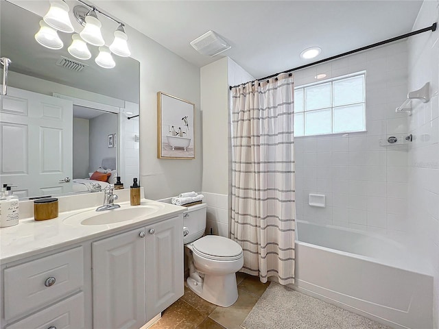 full bathroom with tile patterned floors, shower / tub combo with curtain, vanity, and toilet