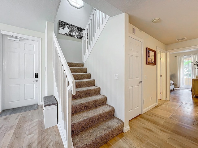 staircase featuring hardwood / wood-style flooring