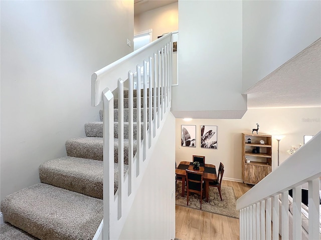 stairway with hardwood / wood-style floors