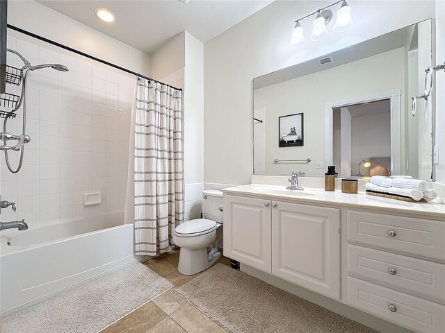 full bathroom with tile patterned flooring, vanity, shower / tub combo, and toilet