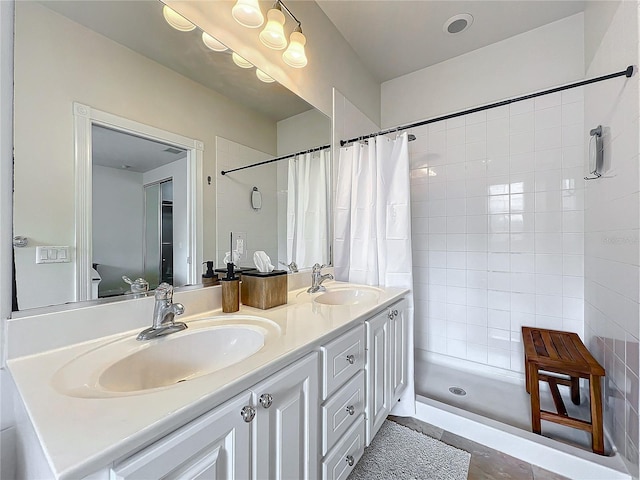 bathroom with a shower with shower curtain and vanity