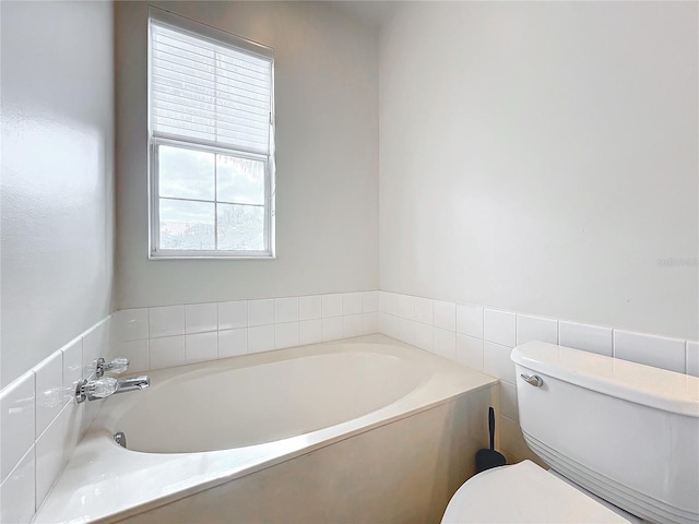 bathroom with toilet and a tub to relax in