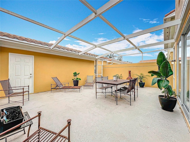 view of patio featuring a lanai