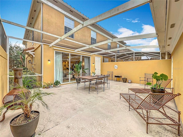 view of patio with glass enclosure