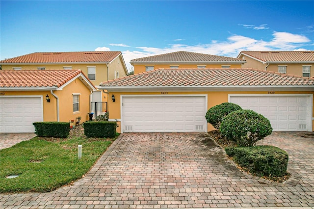 mediterranean / spanish-style home with a garage