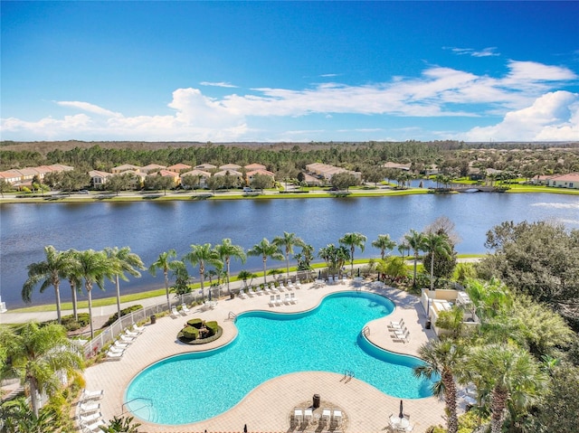 view of pool featuring a patio and a water view