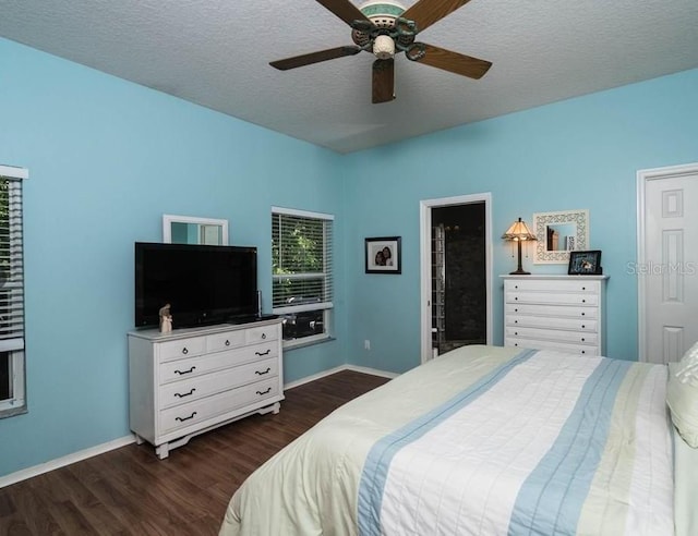 bedroom featuring ceiling fan, dark hardwood / wood-style flooring, and a textured ceiling