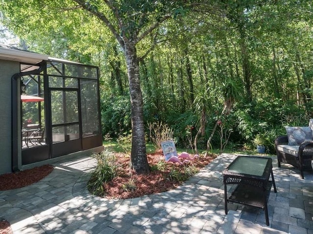 view of patio / terrace featuring a lanai and an outdoor living space