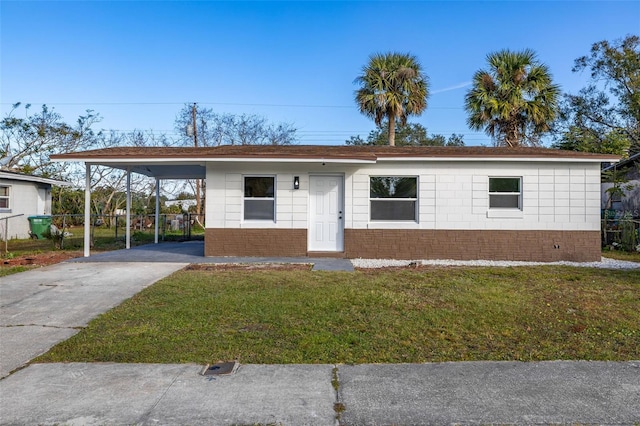 view of front facade with a front lawn and a carport