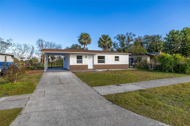 view of front facade with a carport and a front lawn