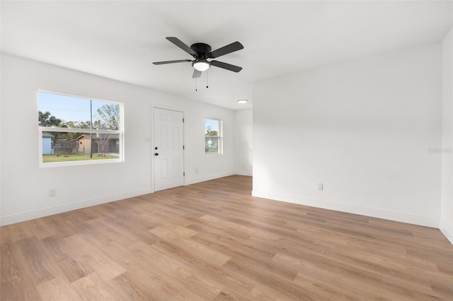 spare room with ceiling fan and light wood-type flooring