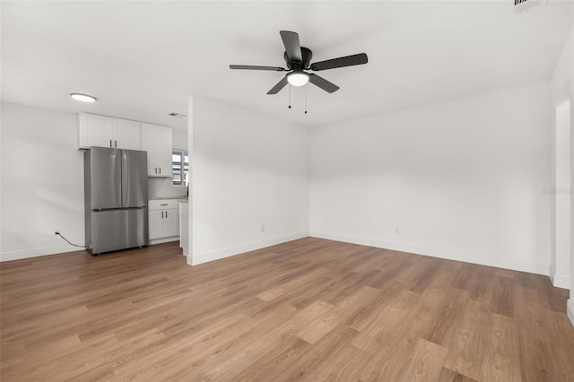 unfurnished living room featuring light wood-type flooring and ceiling fan