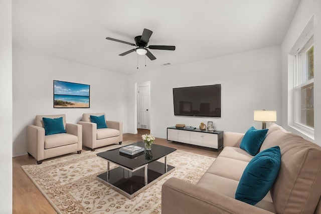 living room with ceiling fan and light hardwood / wood-style floors