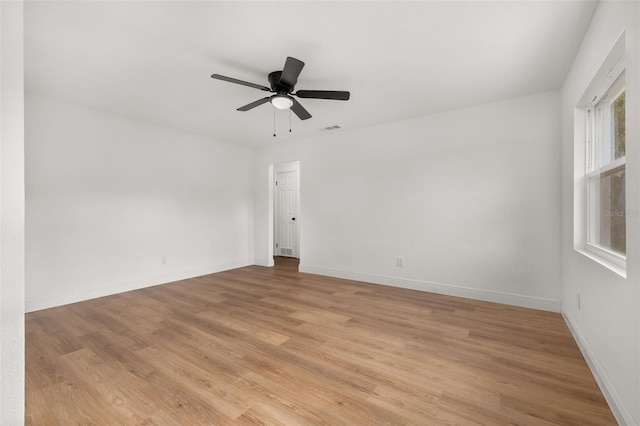 empty room featuring light hardwood / wood-style flooring and ceiling fan