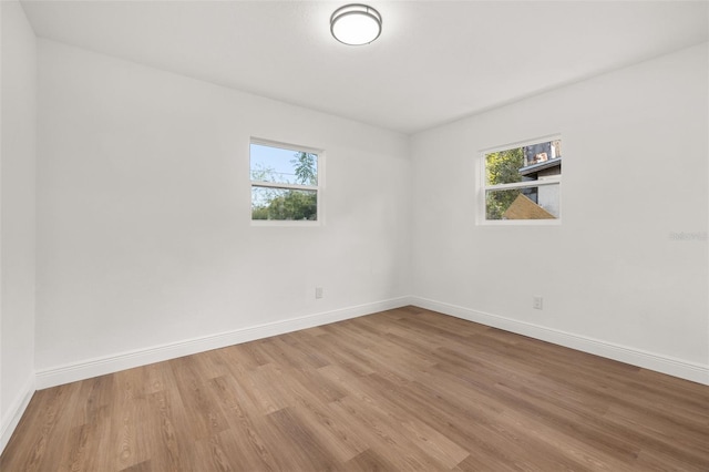 unfurnished room with light hardwood / wood-style floors