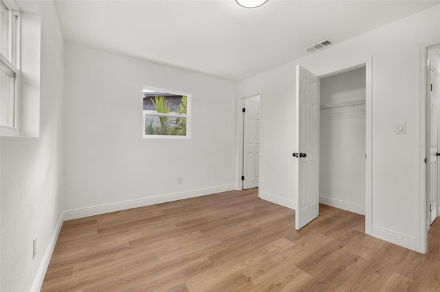 unfurnished bedroom with light hardwood / wood-style floors and a closet