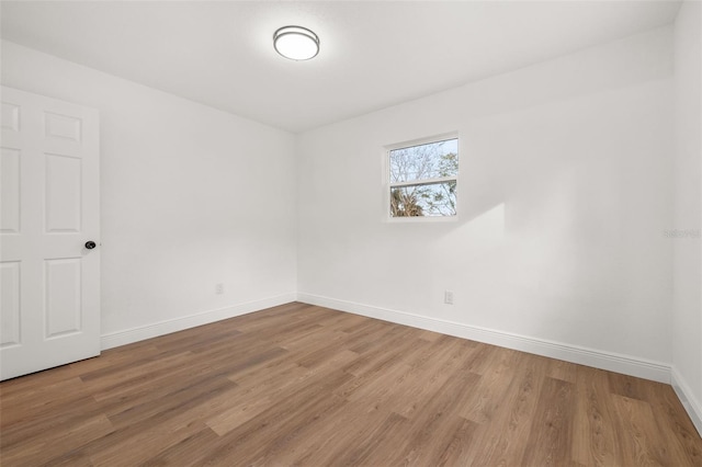 unfurnished room with wood-type flooring