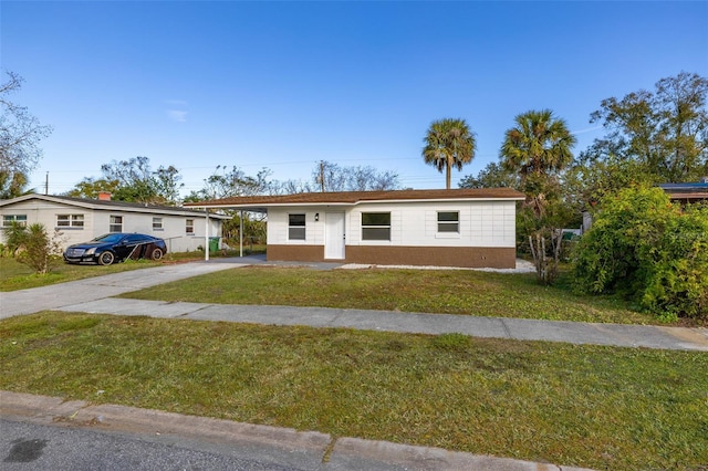 view of front facade featuring a front lawn and a carport