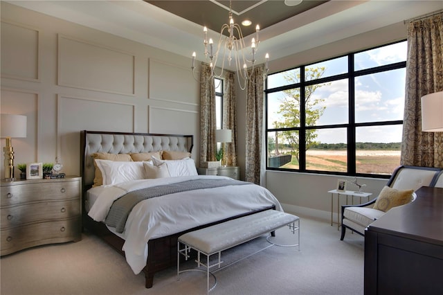 carpeted bedroom with an inviting chandelier