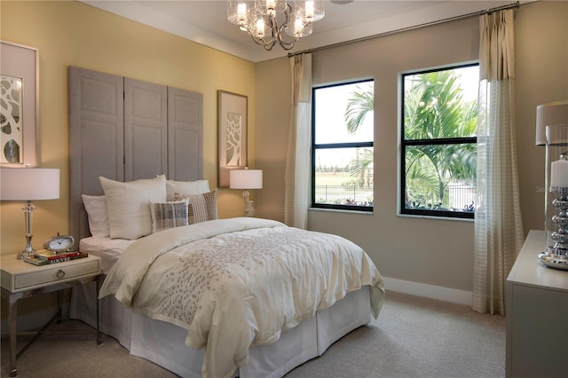 carpeted bedroom featuring a notable chandelier