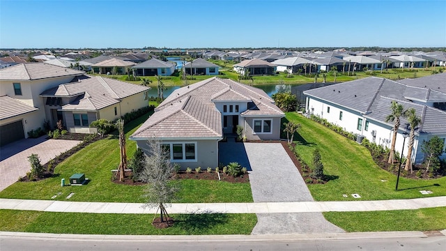 drone / aerial view with a water view and a residential view