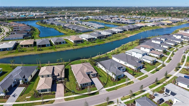 bird's eye view featuring a water view and a residential view
