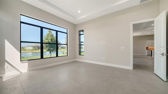 unfurnished room featuring baseboards, light tile patterned floors, and recessed lighting