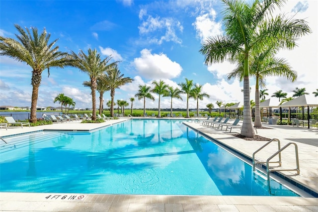 pool with a patio area and fence