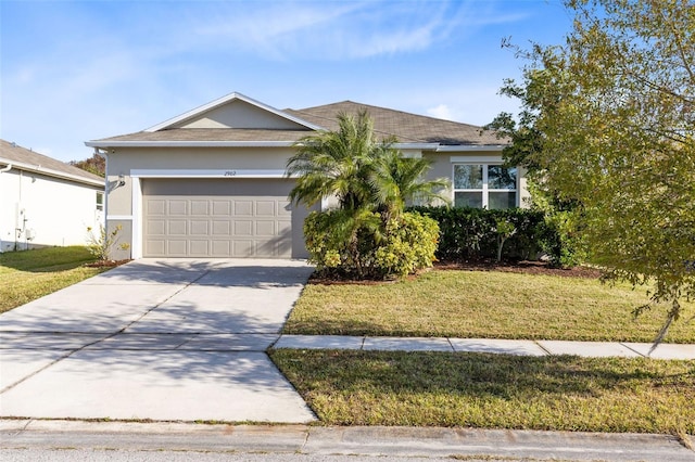 view of front of house featuring a garage and a front yard